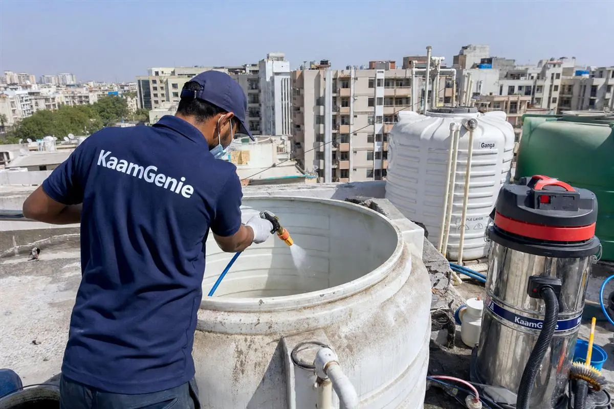 KaamGenie crew cleaning a overhead (rooftop) tank in Dwarka, Delhi