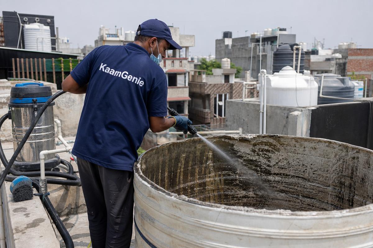 KaamGenie crew cleaning a overhead (rooftop) tank in Fateh Nagar, Delhi