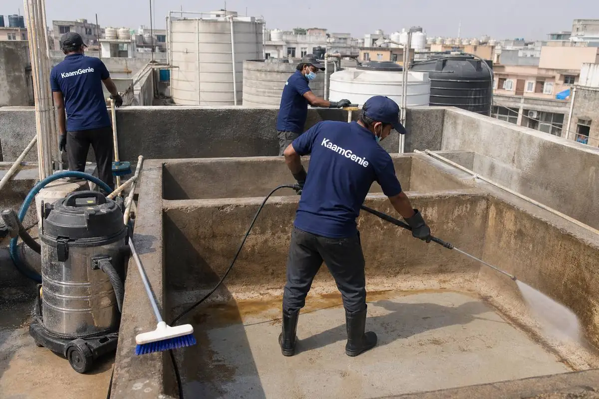 KaamGenie crew cleaning a overhead (rooftop) tank in Gandhi Nagar, Delhi