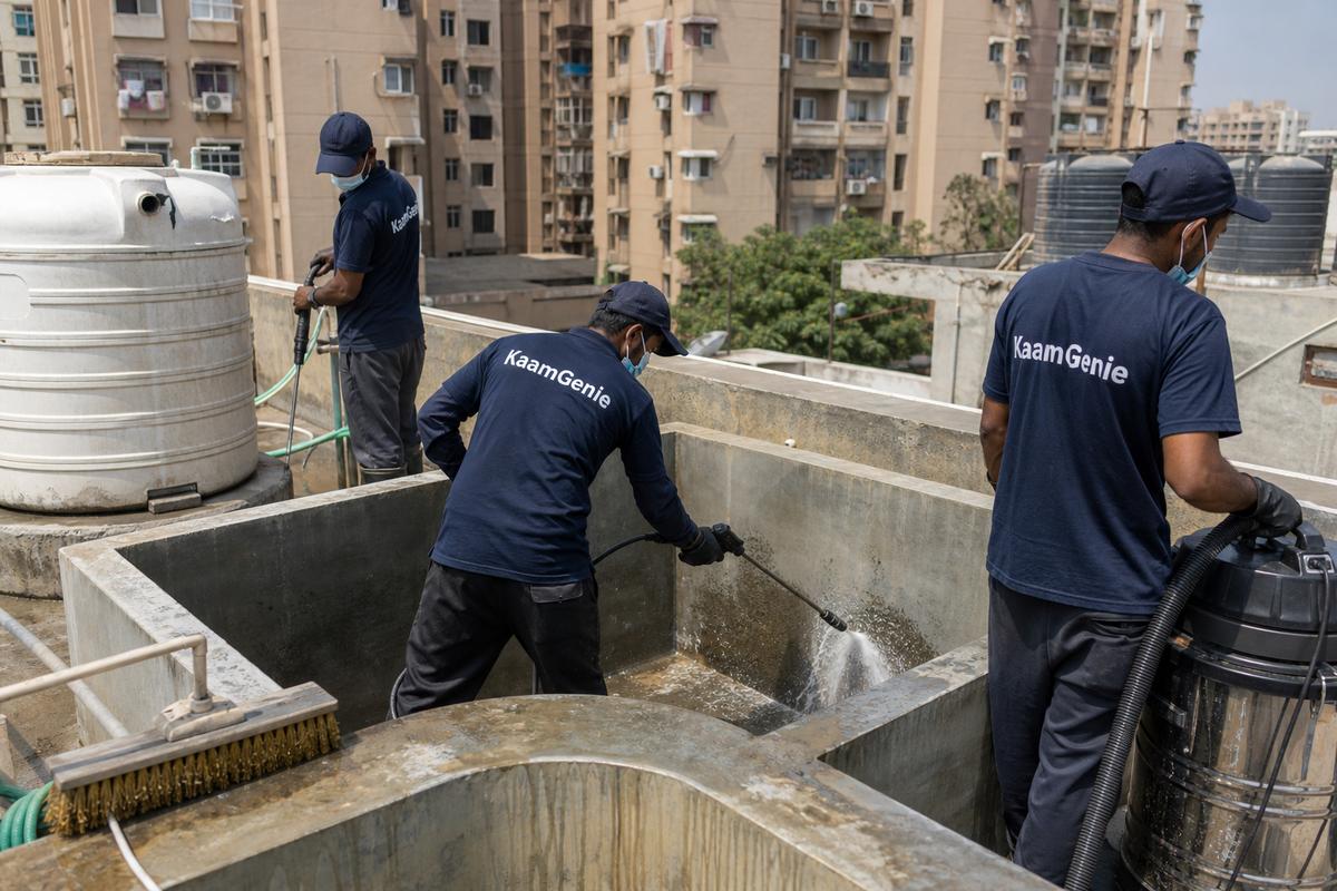 KaamGenie crew cleaning a overhead (rooftop) tank in Gharoli, Delhi