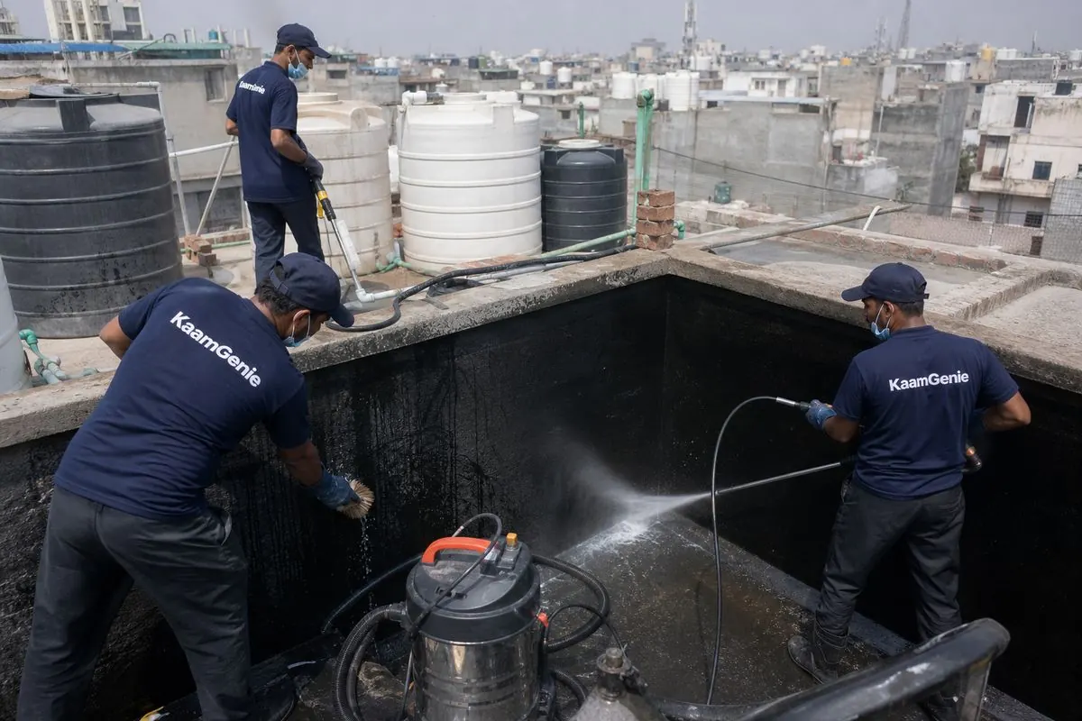 KaamGenie crew cleaning a overhead (rooftop) tank in Gulabi Bagh, Delhi