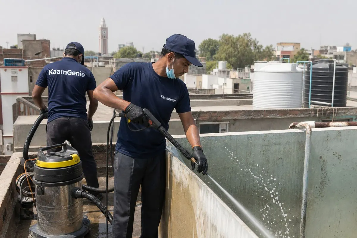 KaamGenie crew cleaning a overhead (rooftop) tank in Hari Nagar, Delhi