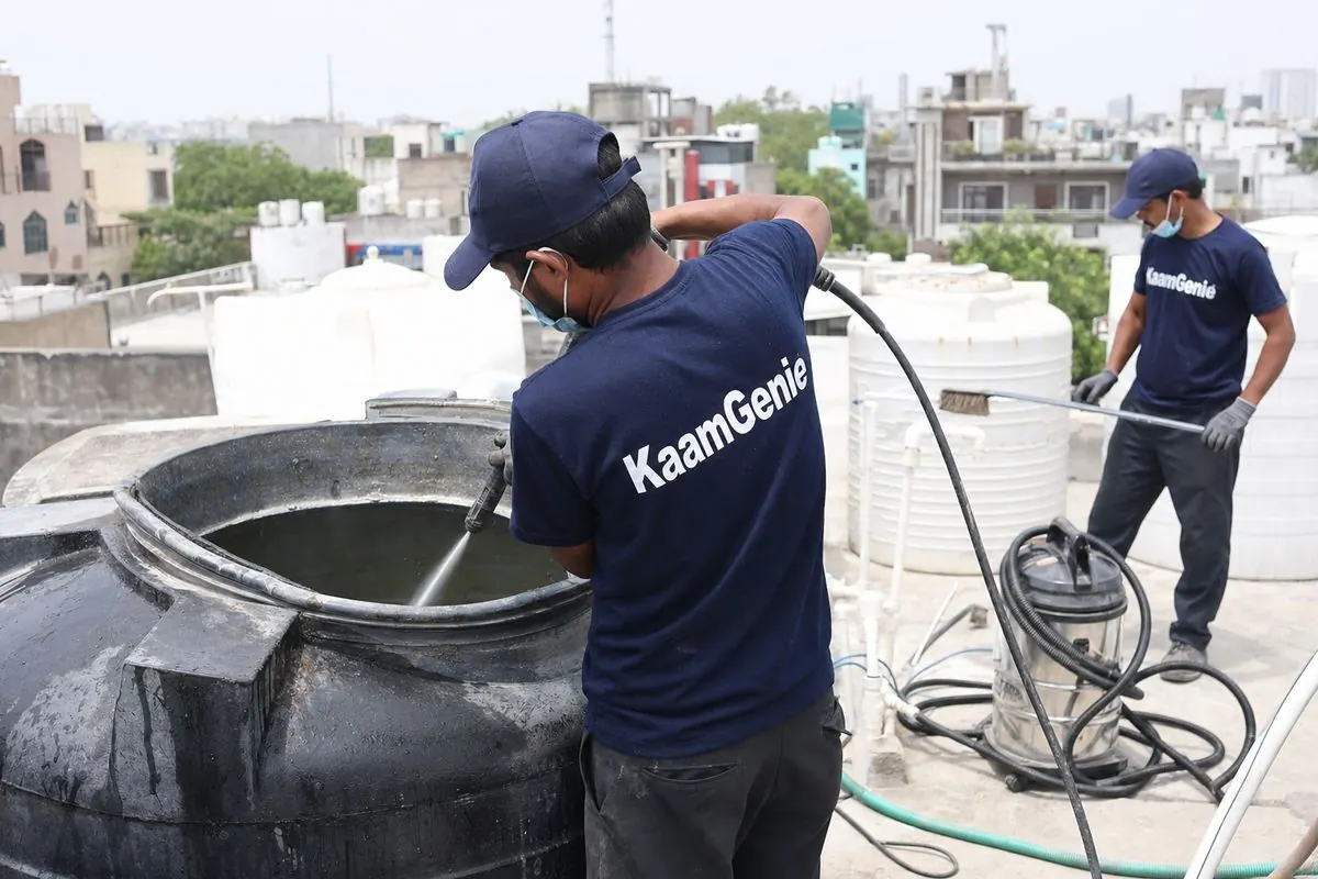 KaamGenie crew cleaning a overhead (rooftop) tank in Hauz Rani, Delhi