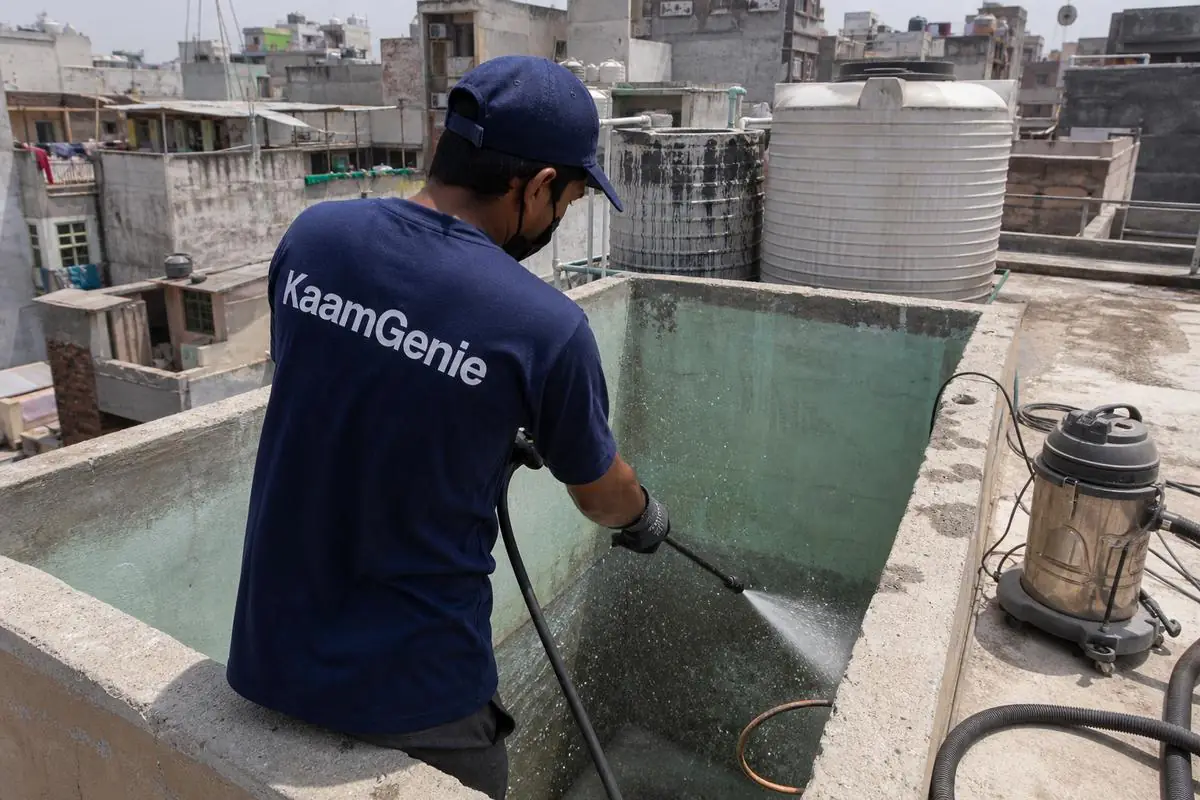KaamGenie crew cleaning a overhead (rooftop) tank in Himmatpuri, Delhi