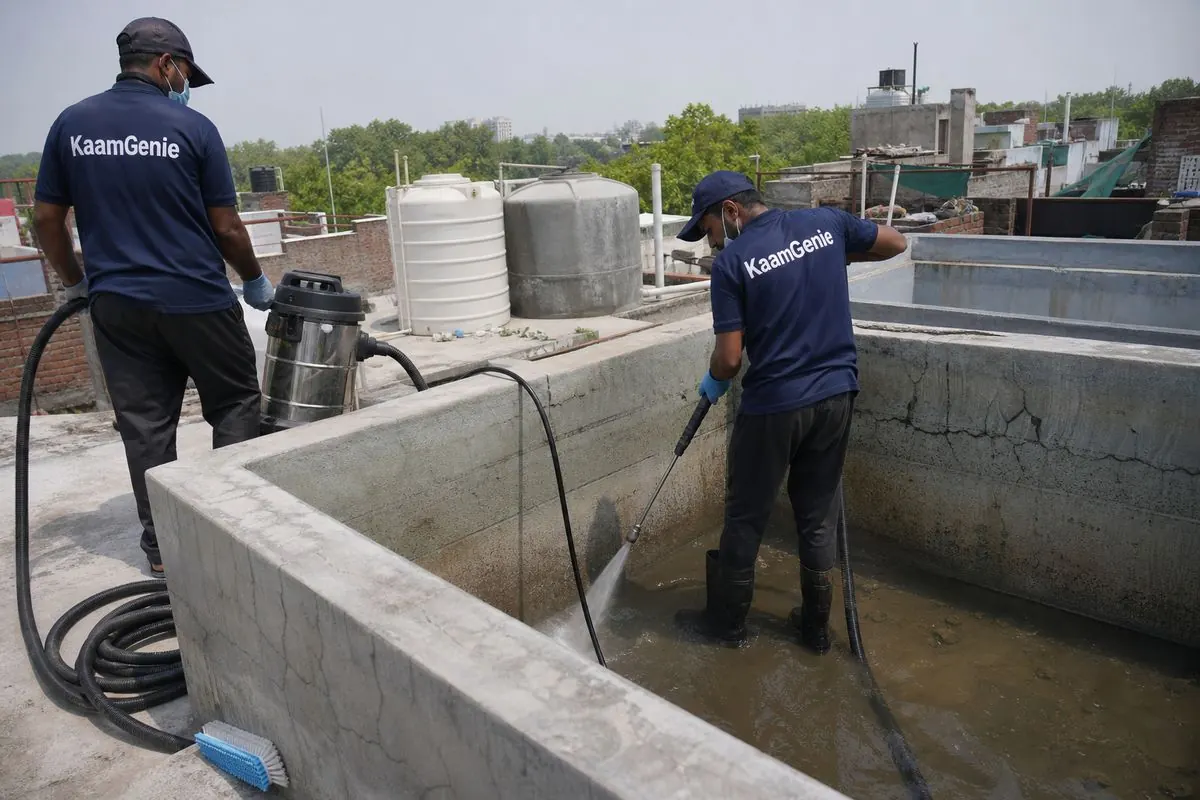 KaamGenie crew cleaning a overhead (rooftop) tank in Inderpuri, Delhi
