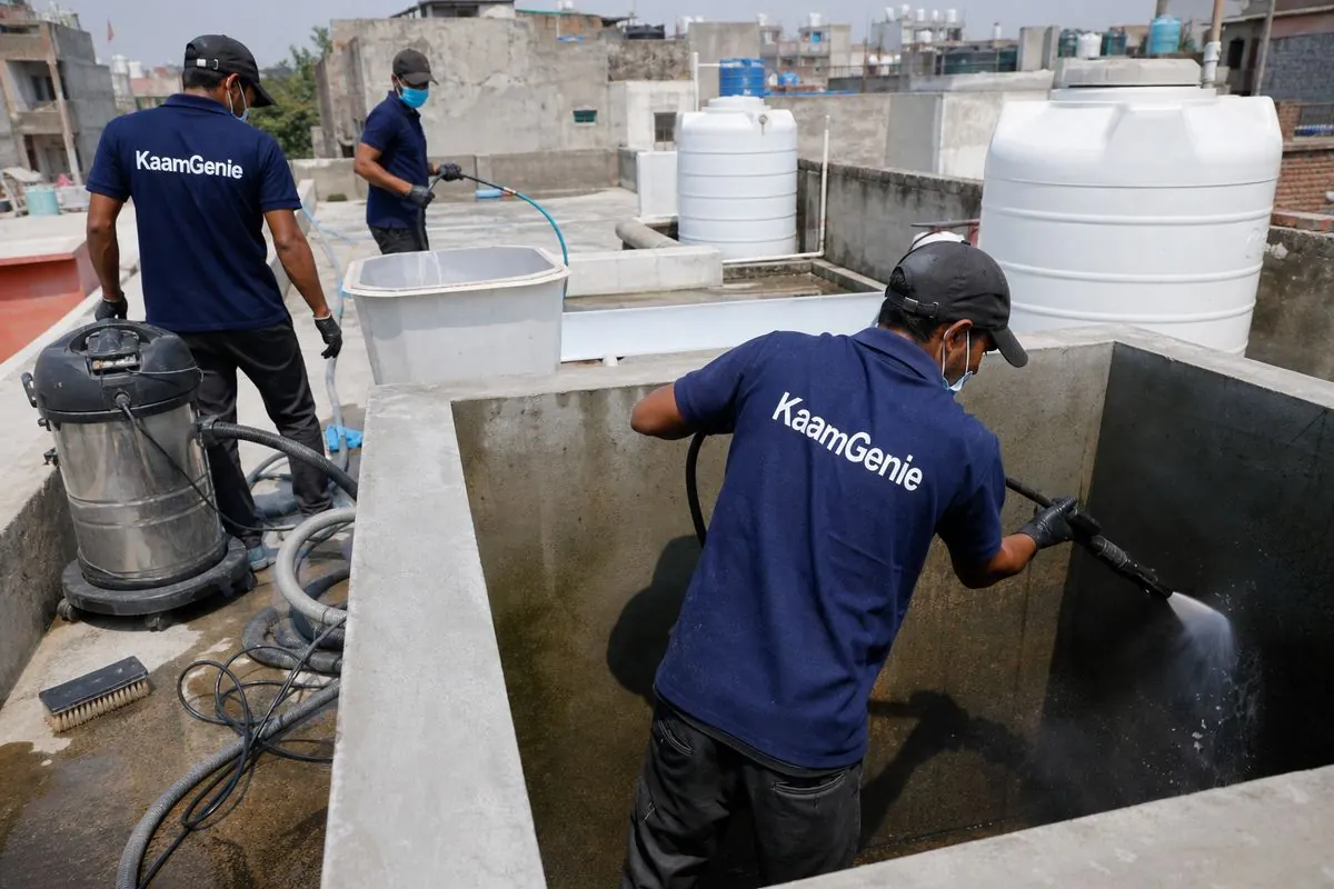 KaamGenie crew cleaning a overhead (rooftop) tank in Jahangir Puri, Delhi