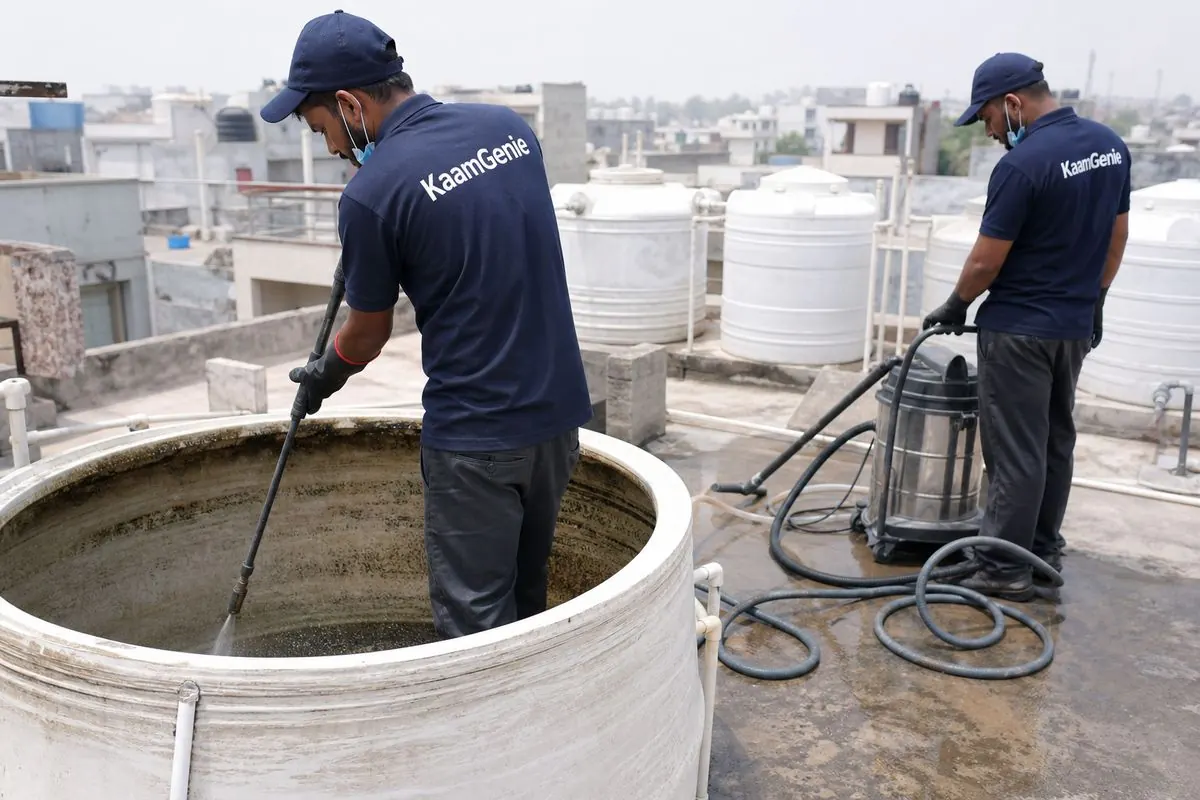KaamGenie crew cleaning a overhead (rooftop) tank in Jal Vihar, Delhi