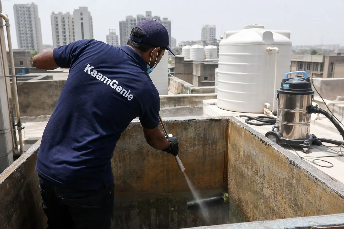 KaamGenie crew cleaning a overhead (rooftop) tank in Janakpuri A Block, Delhi