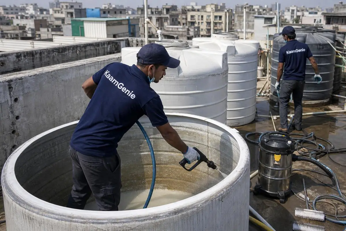 KaamGenie crew cleaning a overhead (rooftop) tank in Johri Farm, Delhi