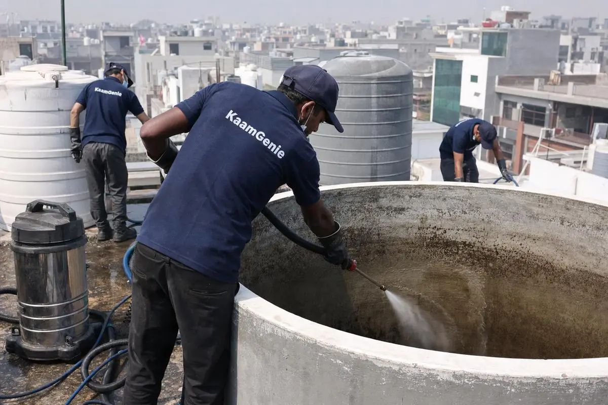 KaamGenie crew cleaning a overhead (rooftop) tank in Jonapur, Delhi