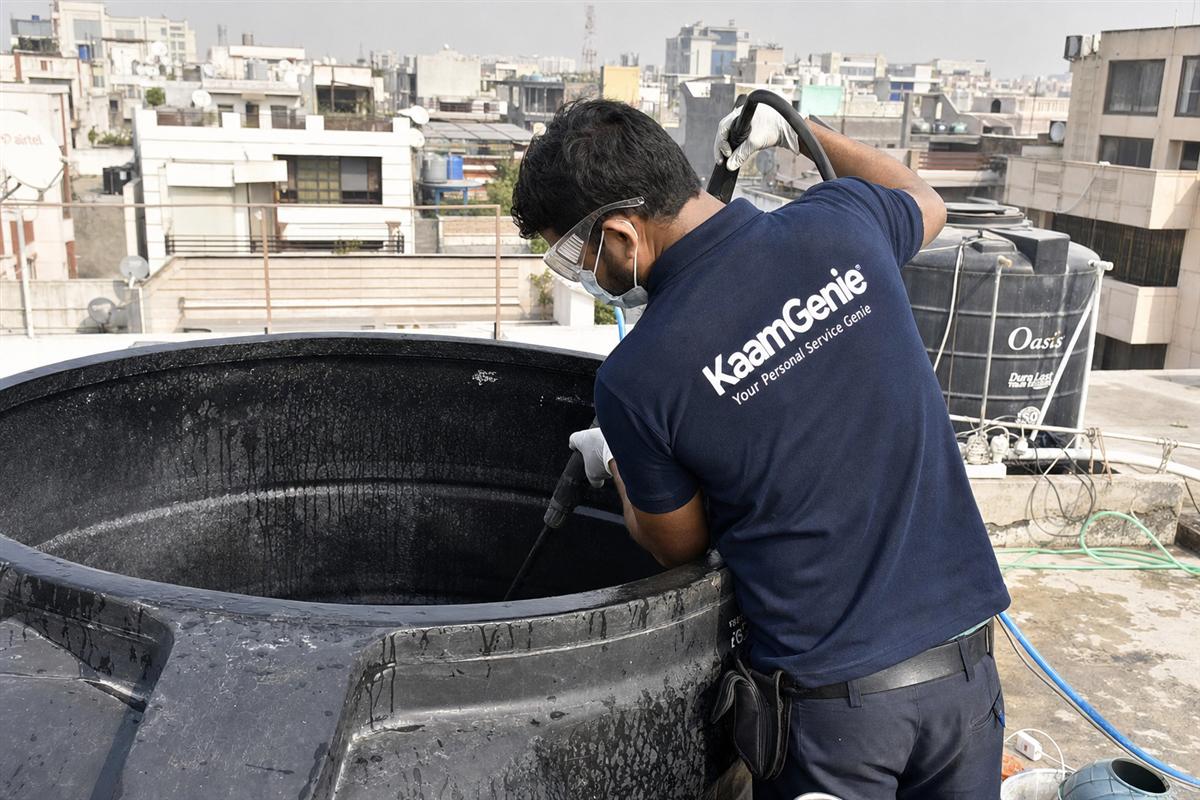 KaamGenie crew cleaning a overhead (rooftop) tank in Kailash Colony, Delhi