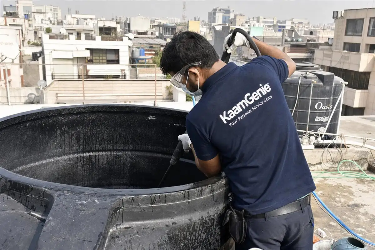 KaamGenie crew cleaning a overhead (rooftop) tank in Kailash Colony, Delhi