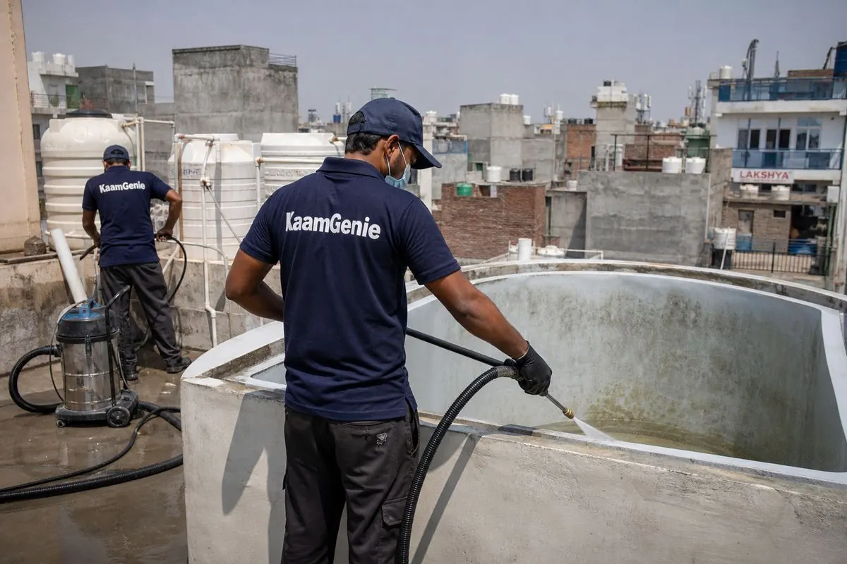 KaamGenie crew cleaning a overhead (rooftop) tank in Kamla Nagar, Delhi