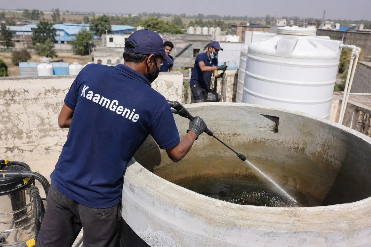 KaamGenie crew cleaning a overhead (rooftop) tank in Kanjhawla, Delhi
