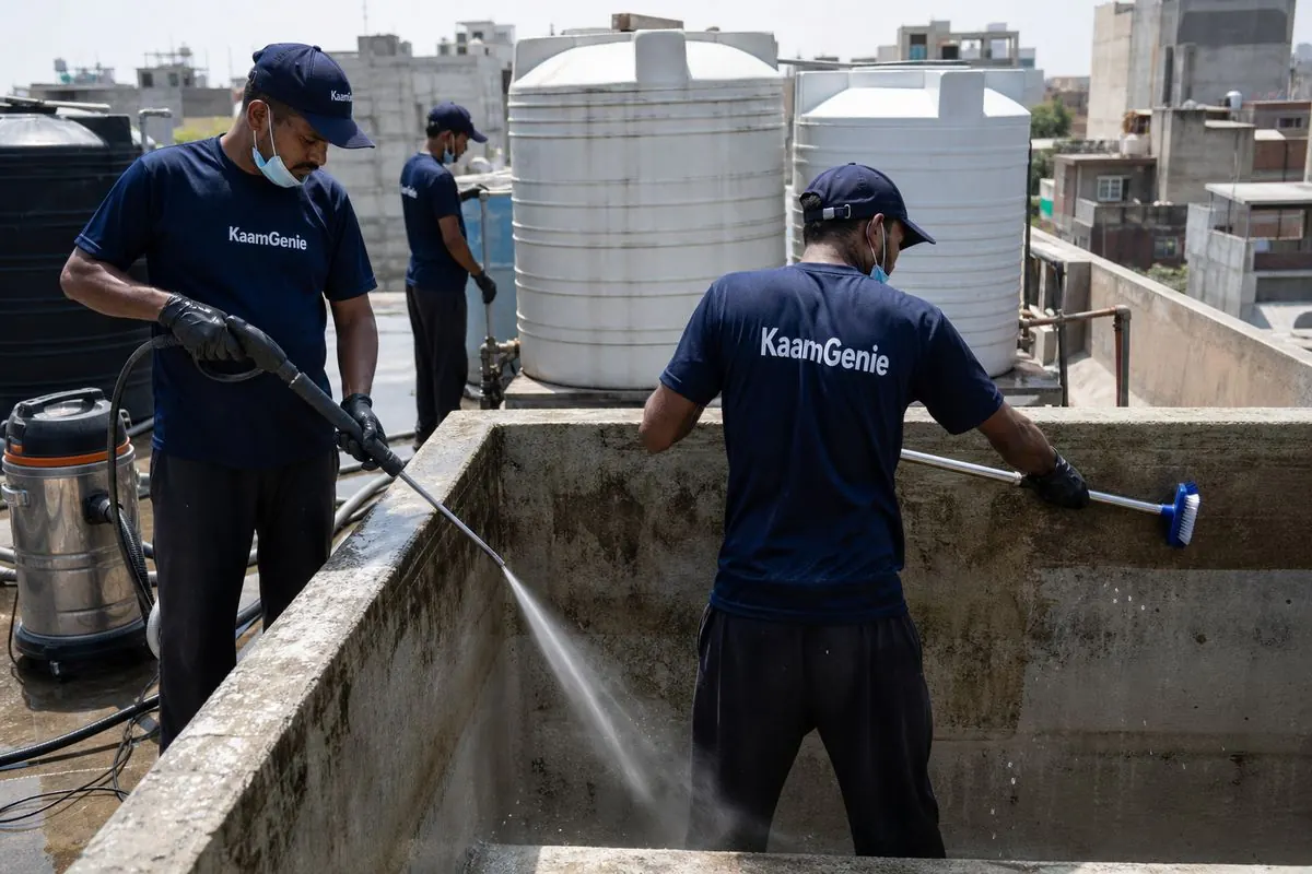 KaamGenie crew cleaning a overhead (rooftop) tank in Karam Pura, Delhi