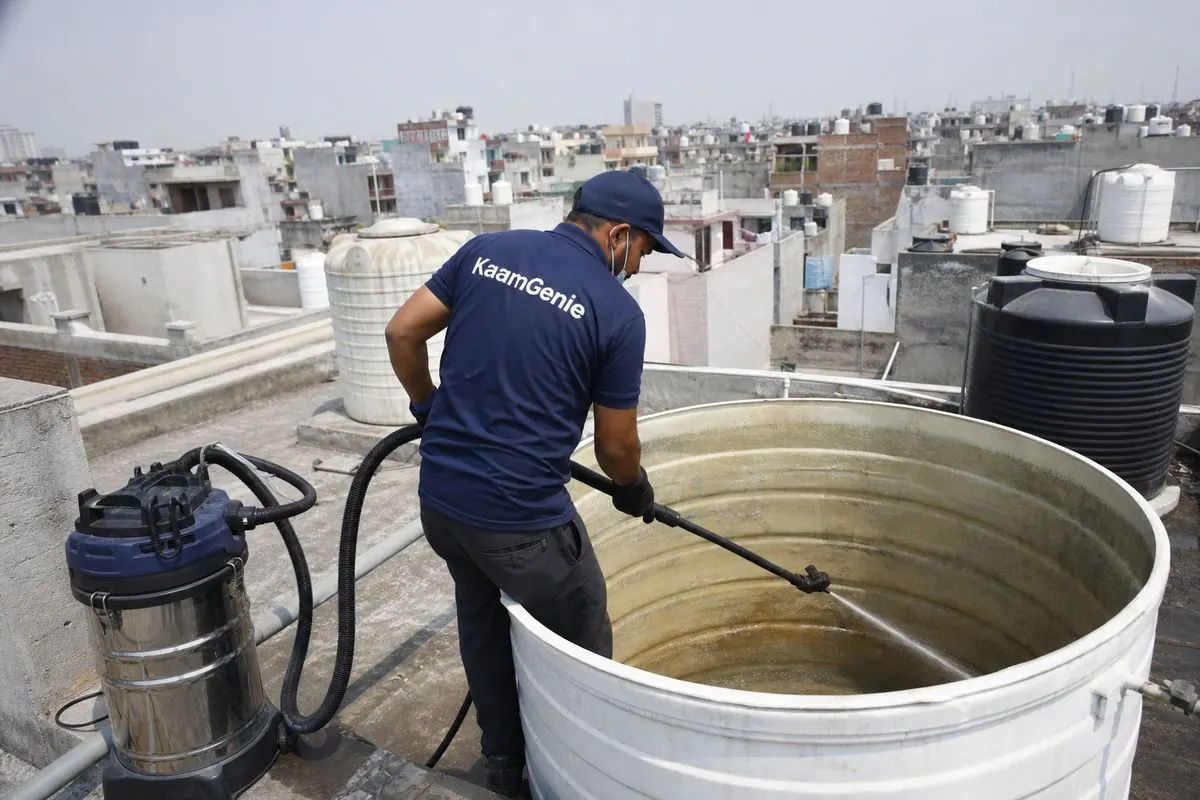 KaamGenie crew cleaning a overhead (rooftop) tank in Kardampuri, Delhi