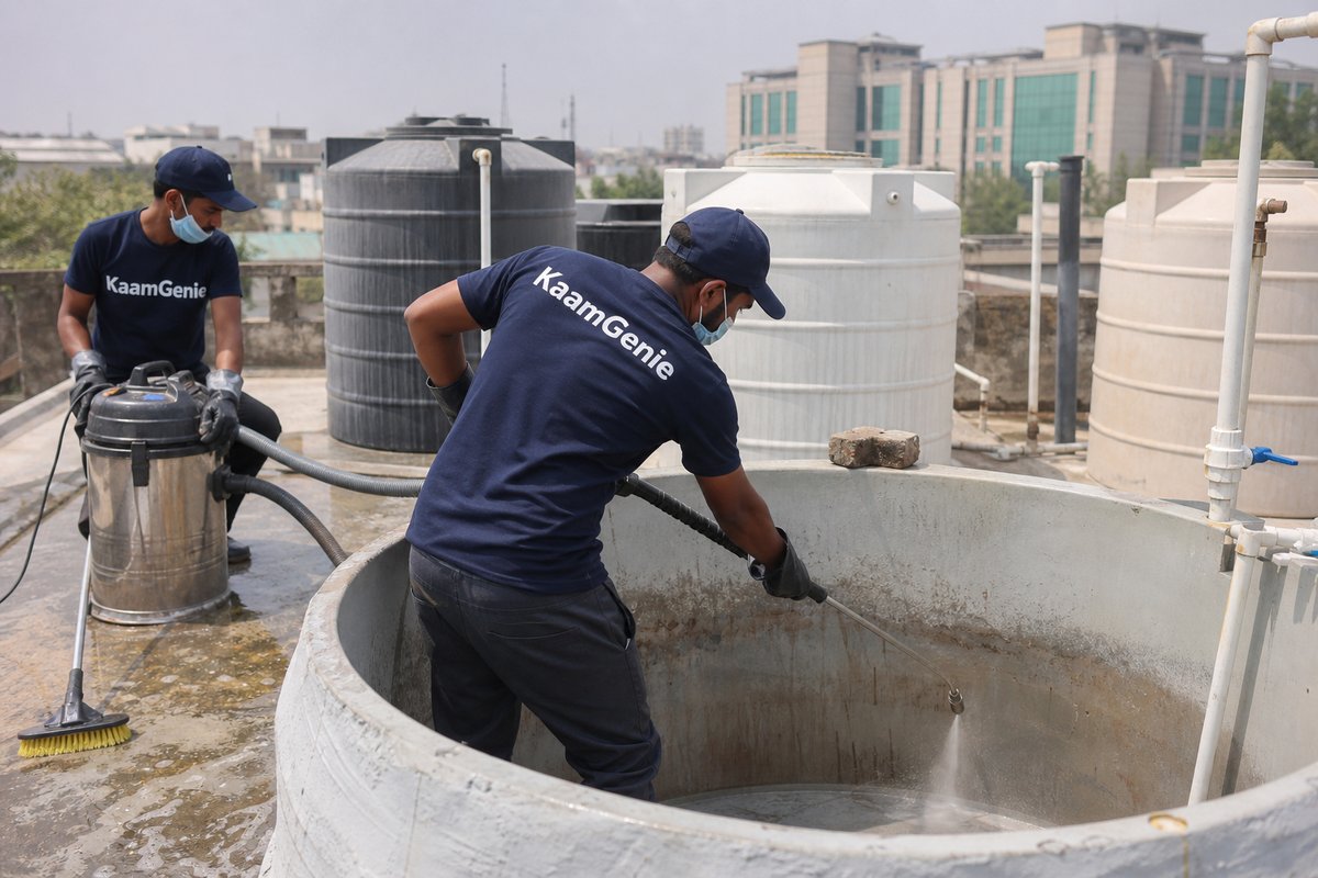 KaamGenie crew cleaning a overhead (rooftop) tank in Karkardooma, Delhi