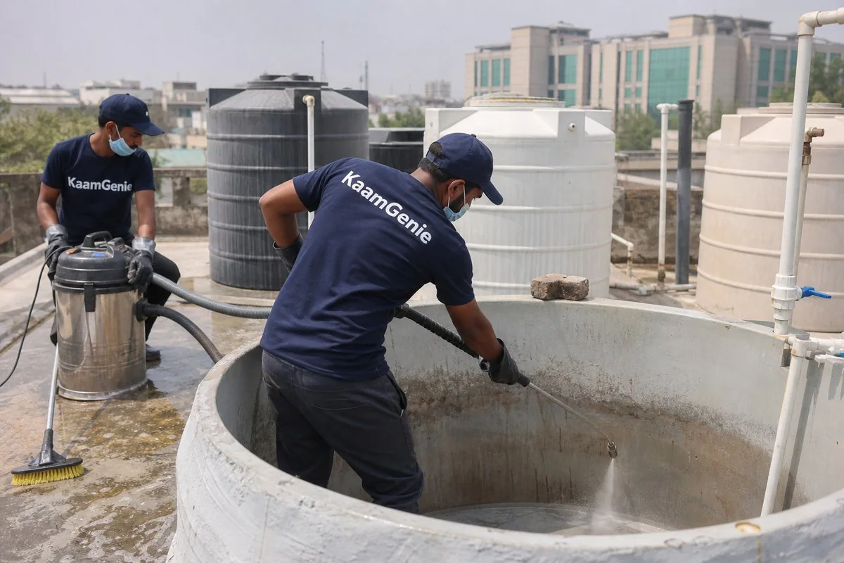 KaamGenie crew cleaning a overhead (rooftop) tank in Karkardooma, Delhi