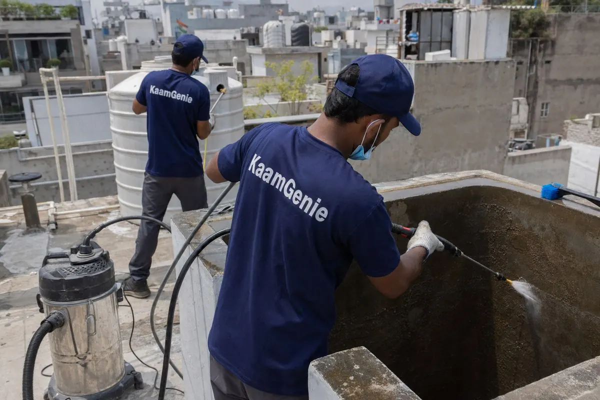 KaamGenie crew cleaning a overhead (rooftop) tank in Khirki Village, Delhi