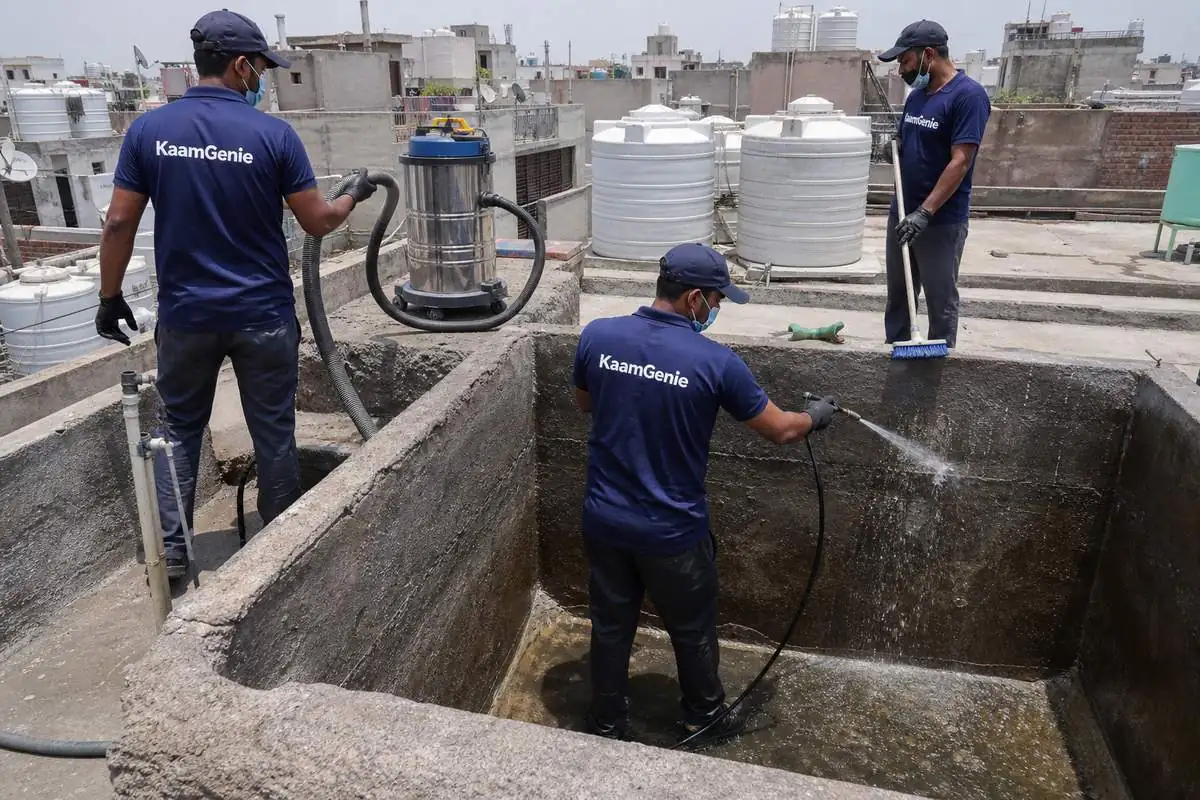 KaamGenie crew cleaning a overhead (rooftop) tank in Khizrabad, Delhi