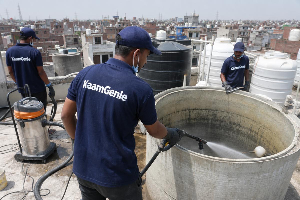 KaamGenie crew cleaning a overhead (rooftop) tank in Kirari Suleman Nagar, Delhi