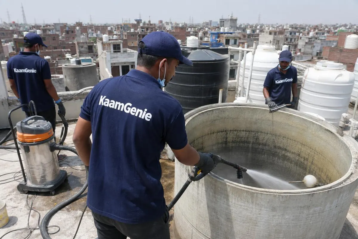 KaamGenie crew cleaning a overhead (rooftop) tank in Kirari Suleman Nagar, Delhi