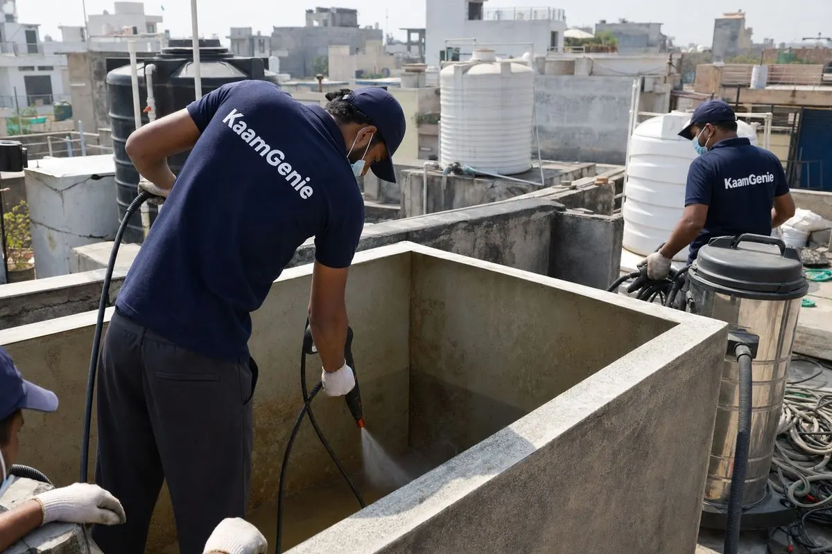 KaamGenie crew cleaning a overhead (rooftop) tank in Kishangarh, Delhi
