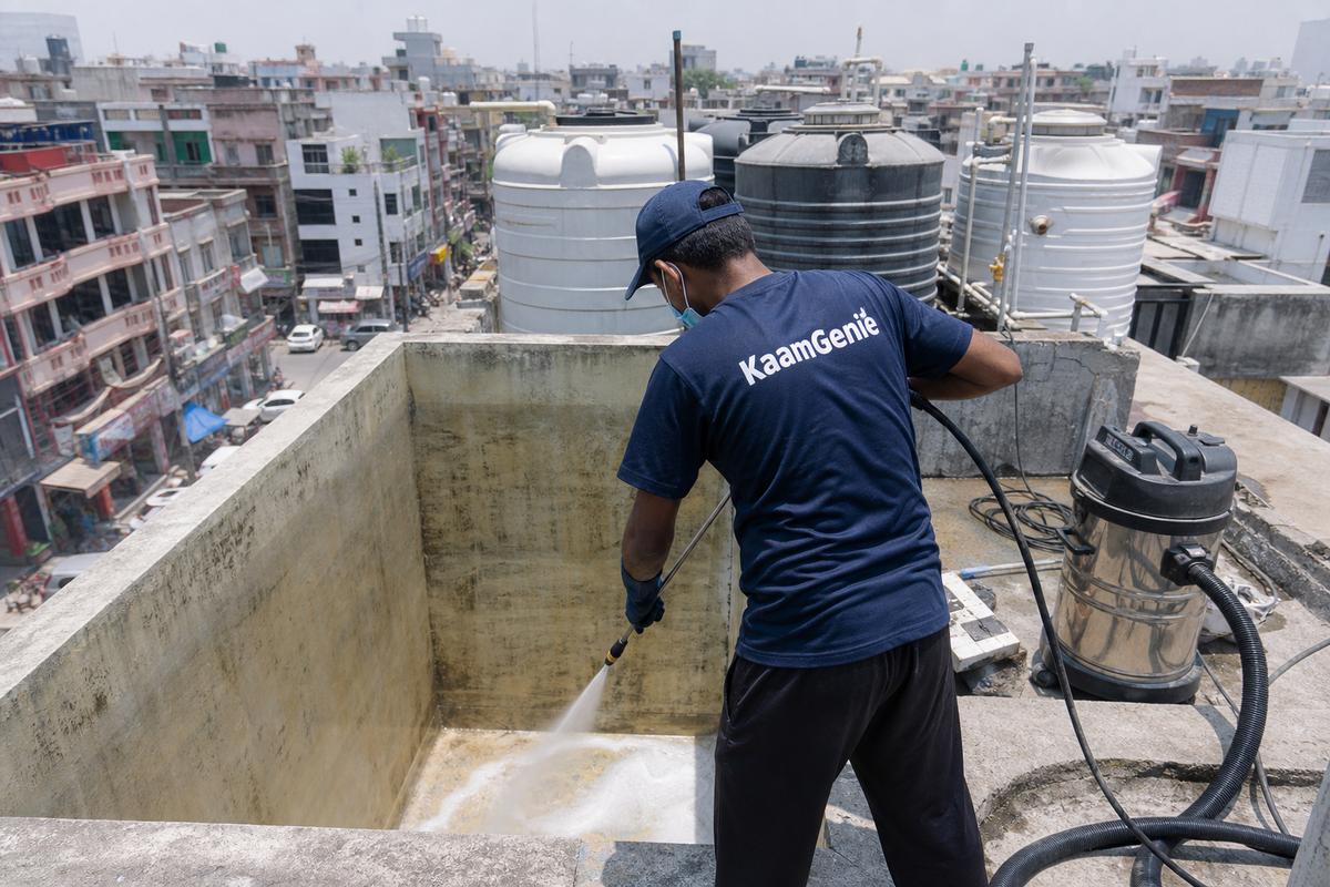 KaamGenie crew cleaning a overhead (rooftop) tank in Krishna Nagar, Delhi