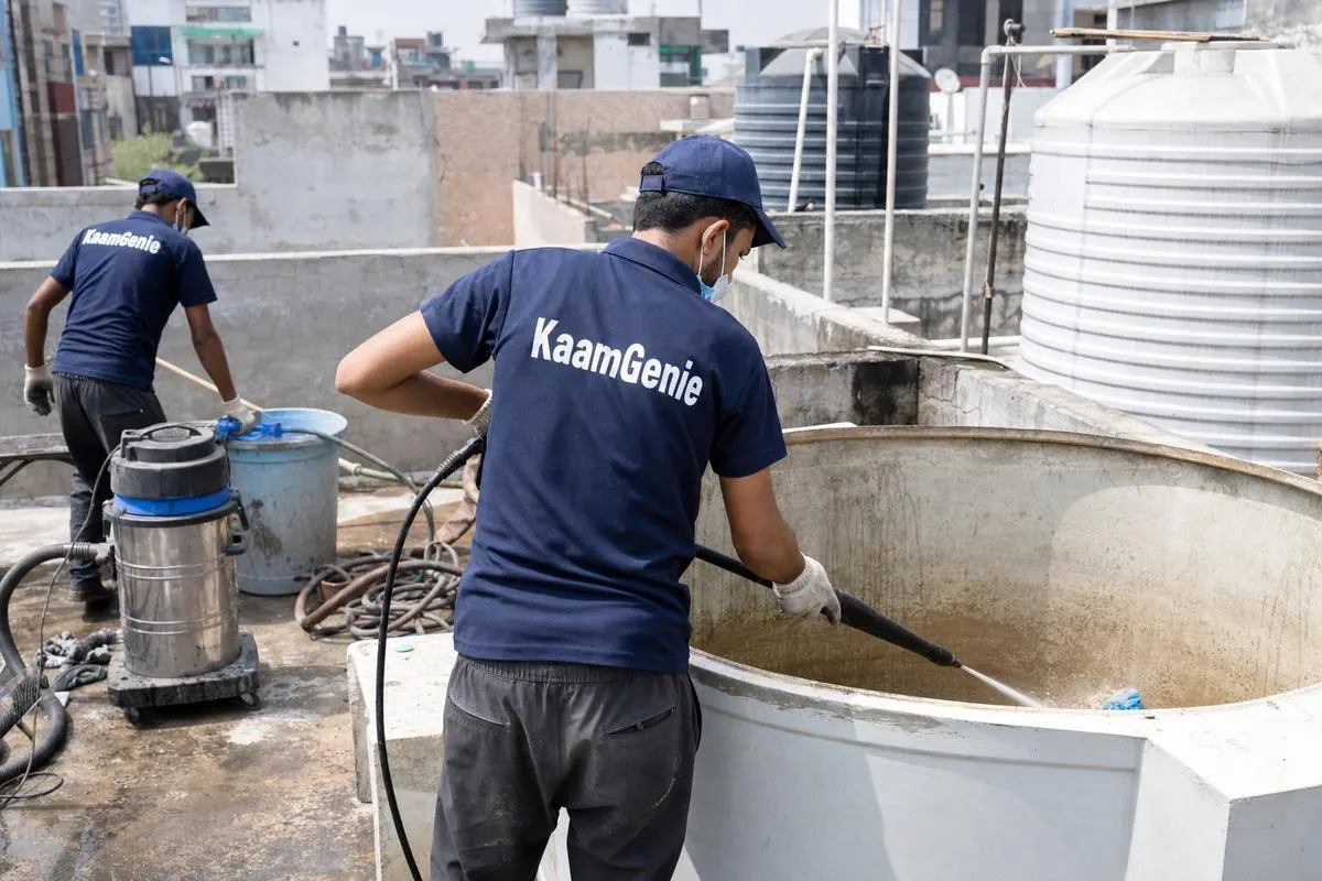 KaamGenie crew cleaning a overhead (rooftop) tank in Lado Sarai, Delhi