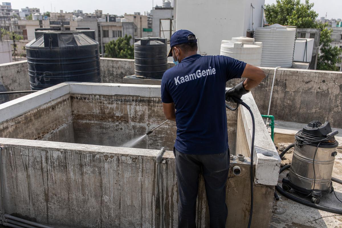 KaamGenie crew cleaning a overhead (rooftop) tank in Lajpat Nagar 4, Delhi