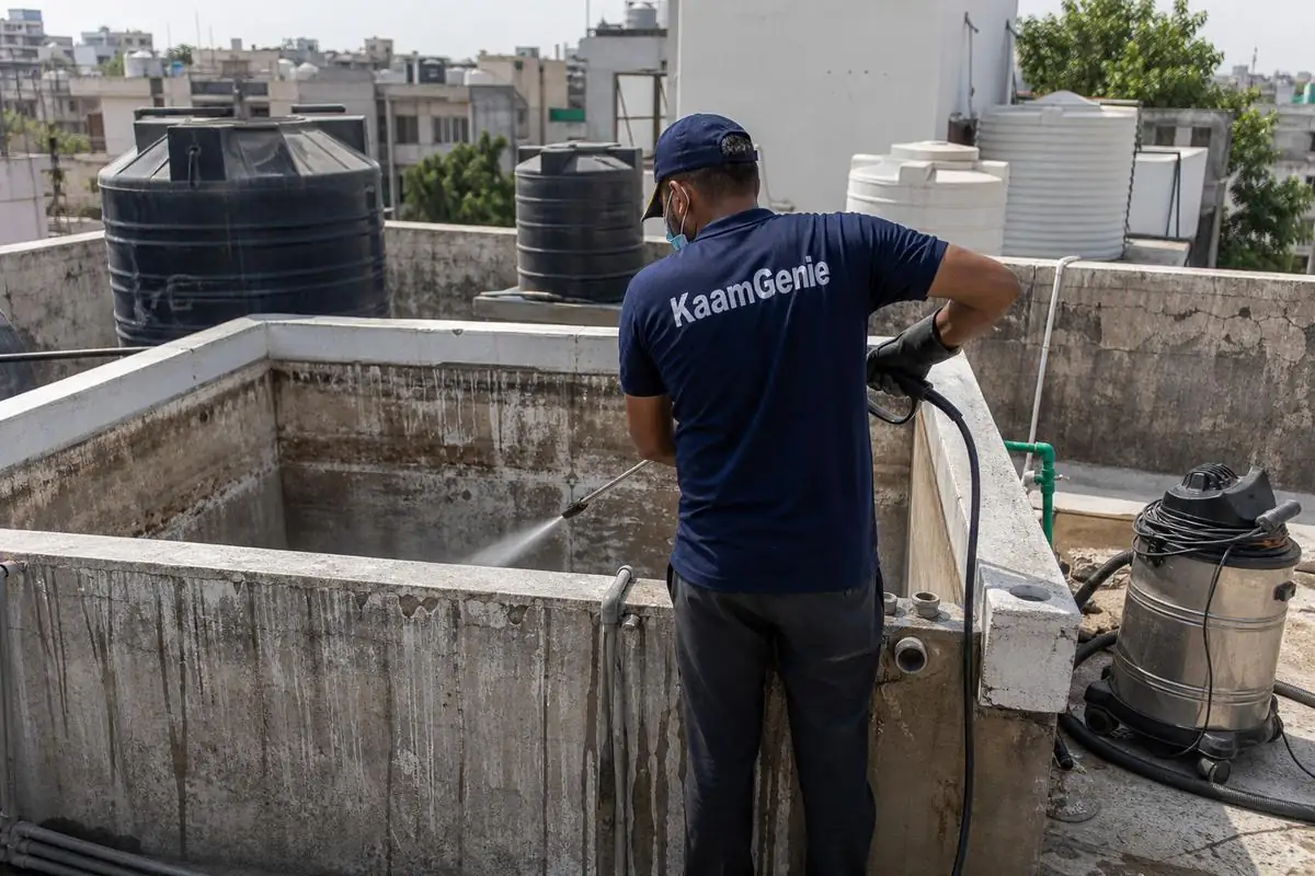KaamGenie crew cleaning a overhead (rooftop) tank in Lajpat Nagar 4, Delhi