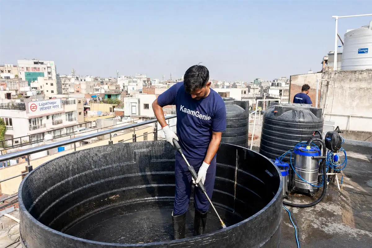 KaamGenie crew cleaning a overhead (rooftop) tank in Lajpat Nagar, Delhi