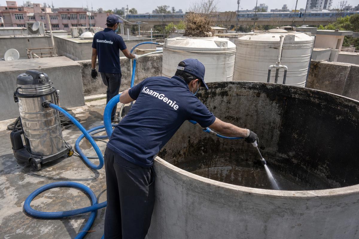 KaamGenie crew cleaning a overhead (rooftop) tank in Laxmibai Nagar, Delhi