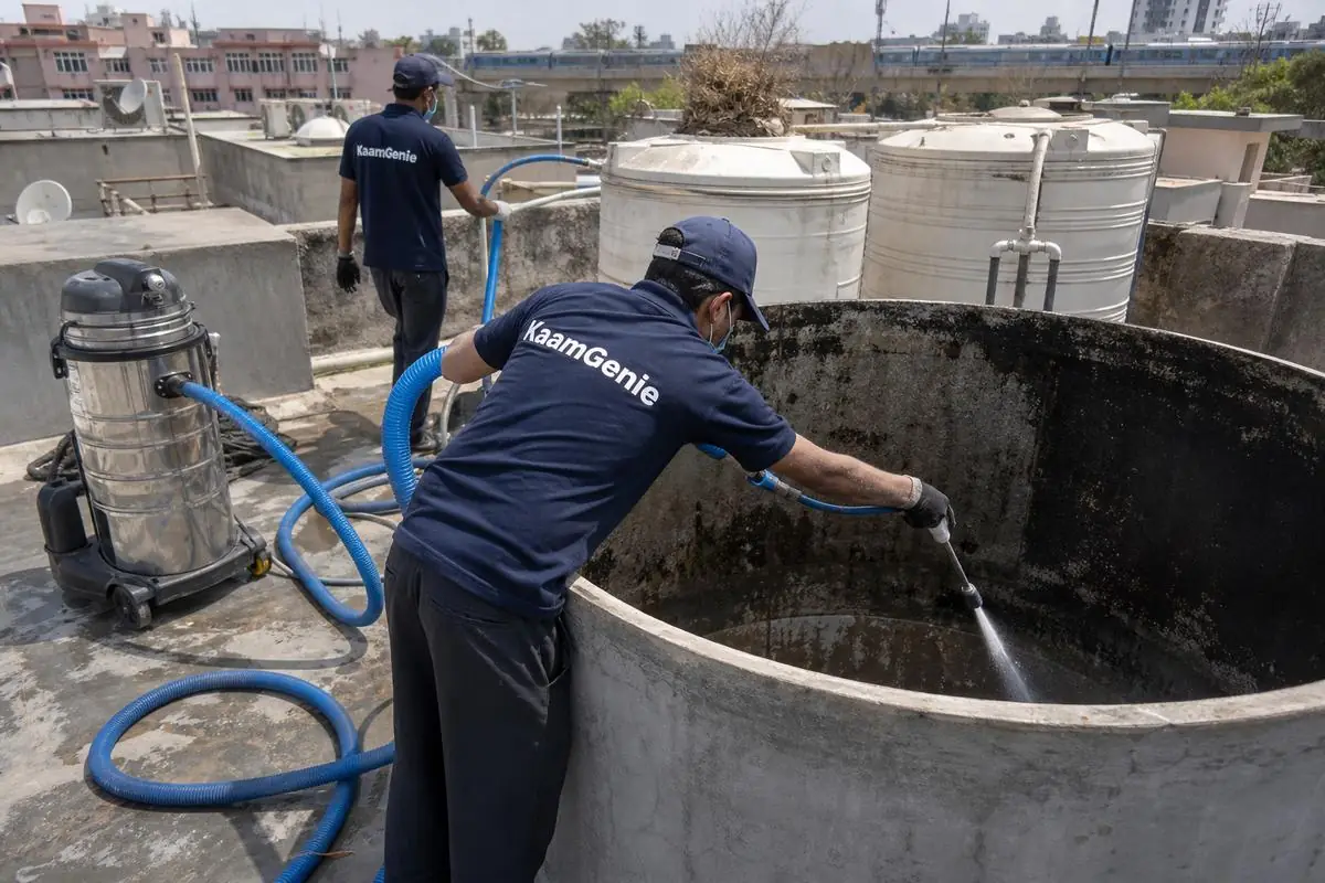 KaamGenie crew cleaning a overhead (rooftop) tank in Laxmibai Nagar, Delhi