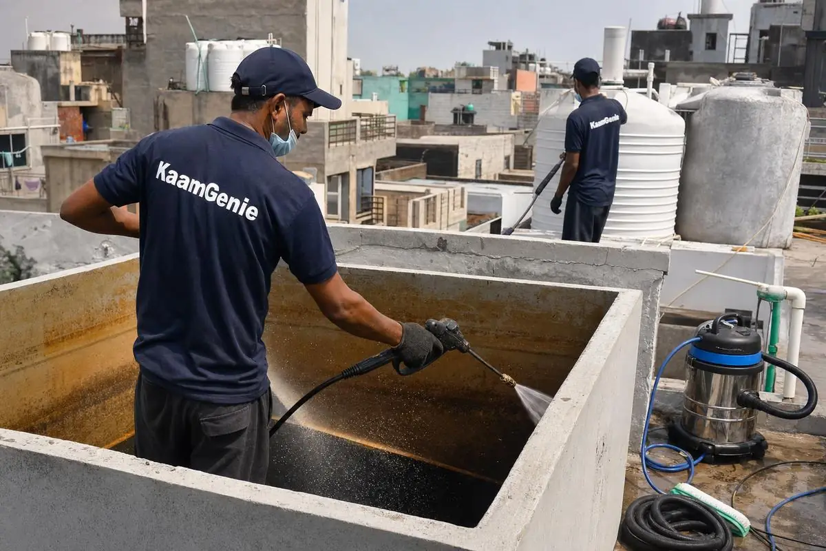 KaamGenie crew cleaning a overhead (rooftop) tank in Madanpur Khadar, Delhi