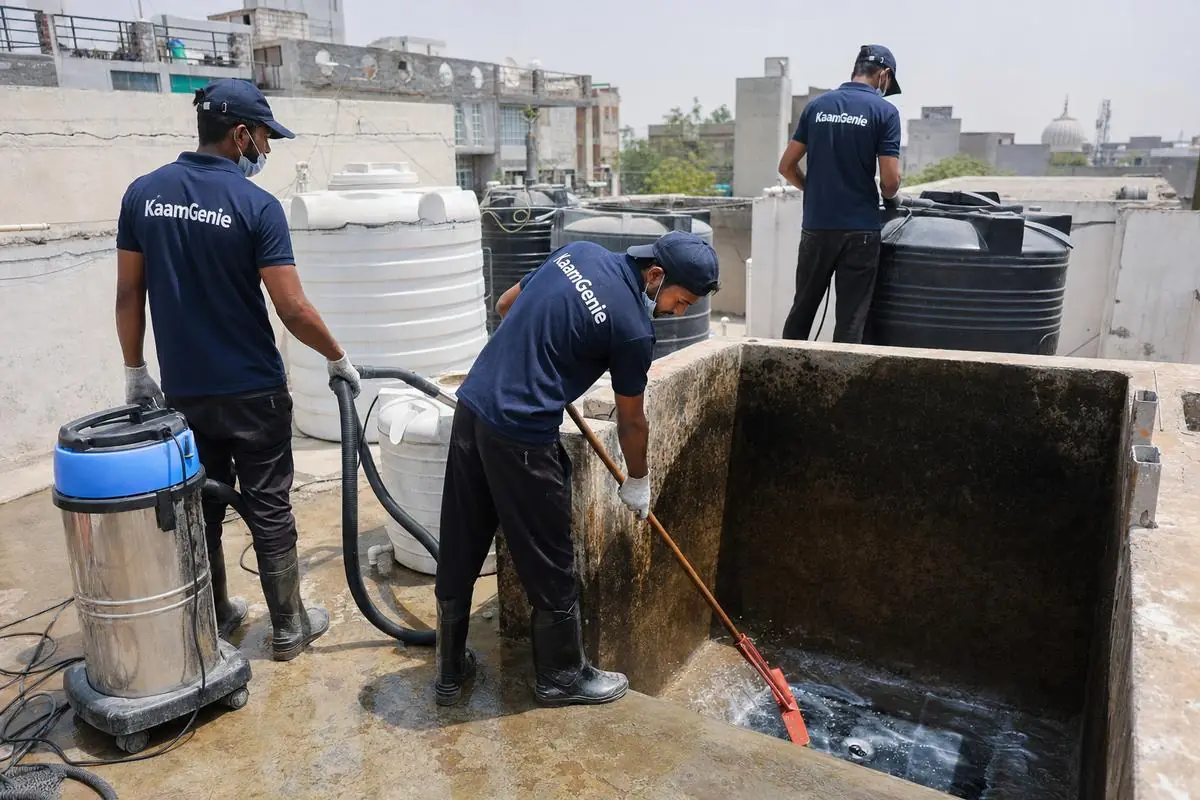 KaamGenie crew cleaning a overhead (rooftop) tank in Maidan Garhi, Delhi