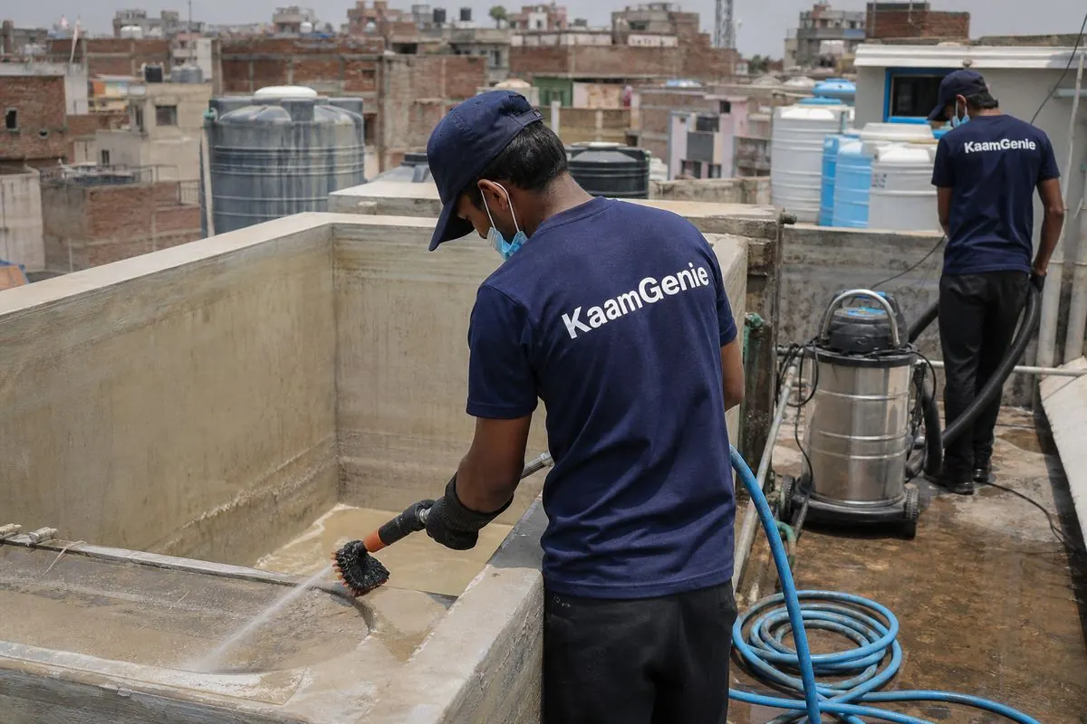 KaamGenie crew cleaning a overhead (rooftop) tank in Malka Ganj, Delhi