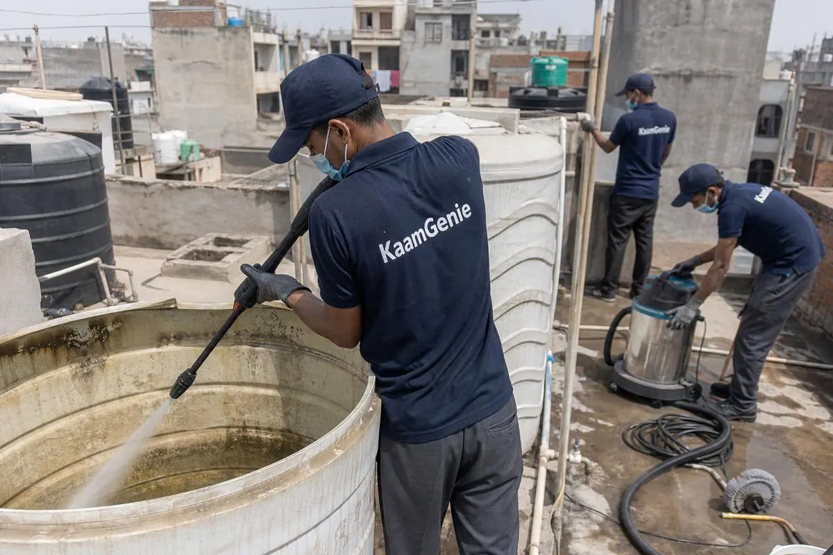 KaamGenie crew cleaning a overhead (rooftop) tank in Mandawali Fazalpur, Delhi