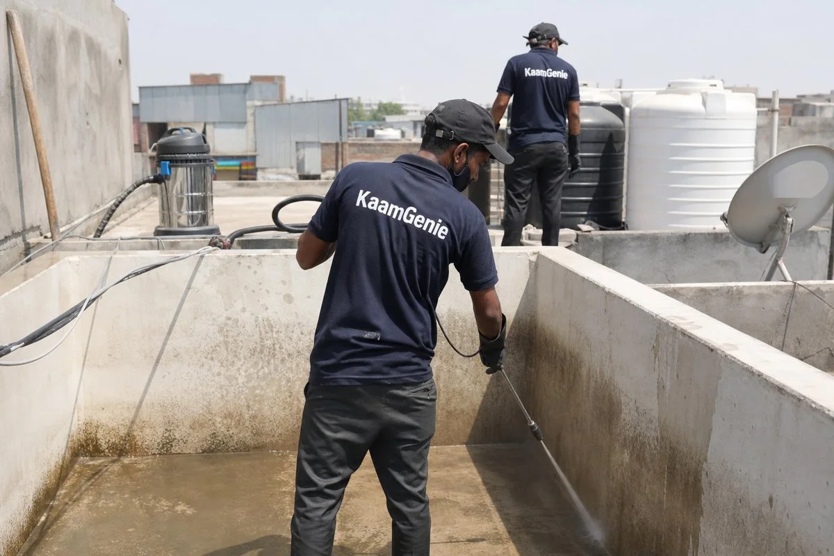 KaamGenie crew cleaning a overhead (rooftop) tank in Mangolpuri, Delhi