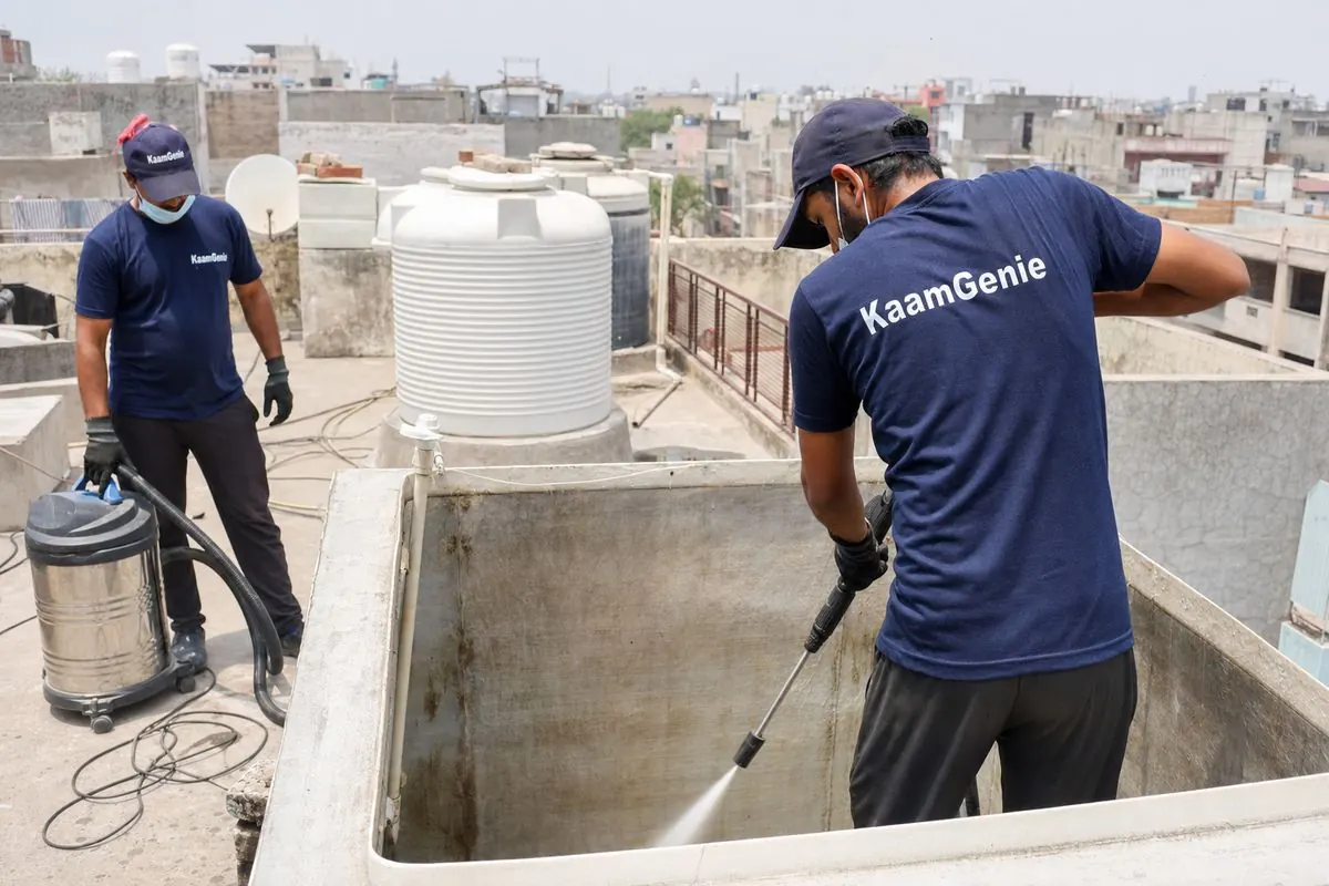 KaamGenie crew cleaning a overhead (rooftop) tank in Molarband, Delhi