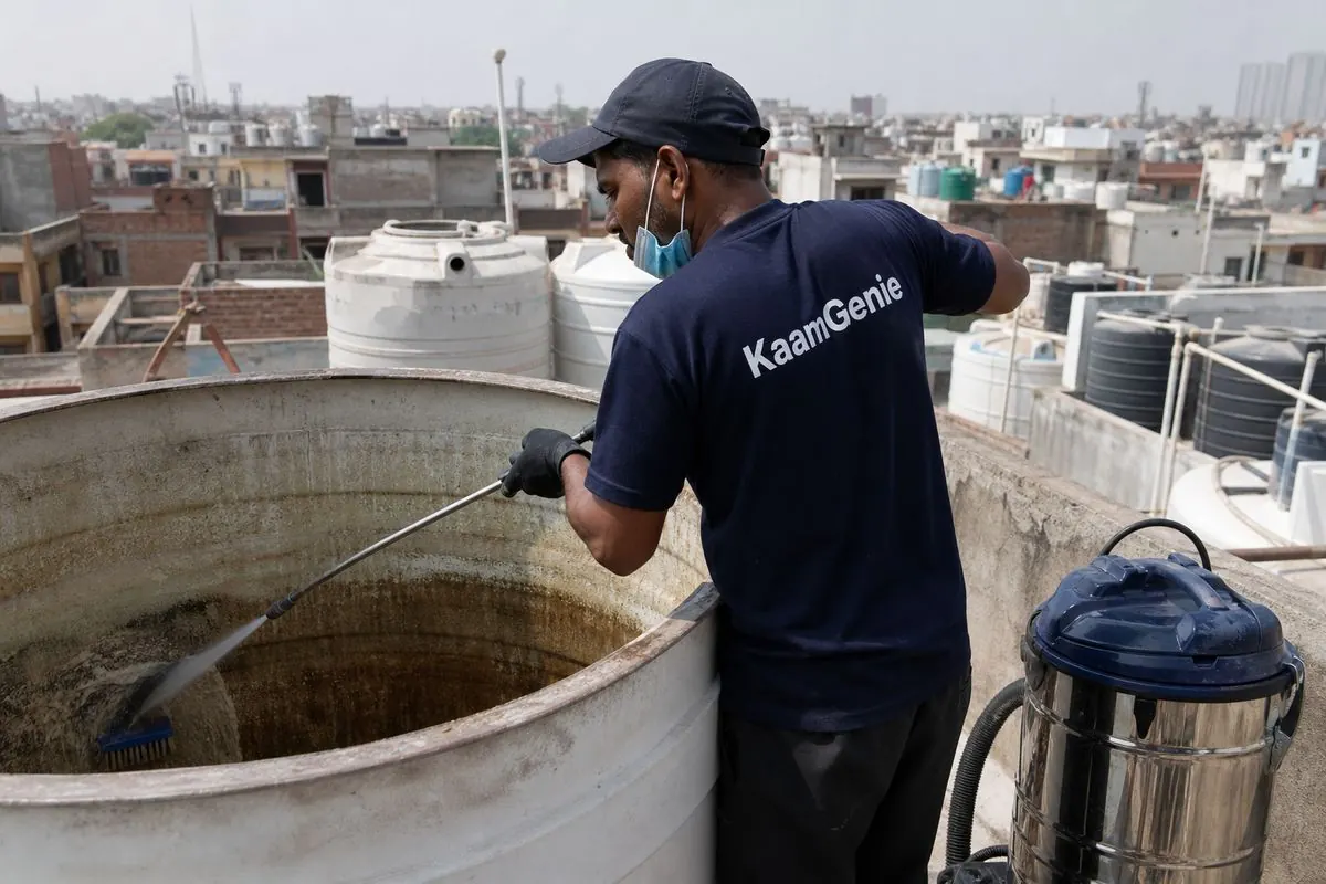 KaamGenie crew cleaning a overhead (rooftop) tank in Mustafabad, Delhi