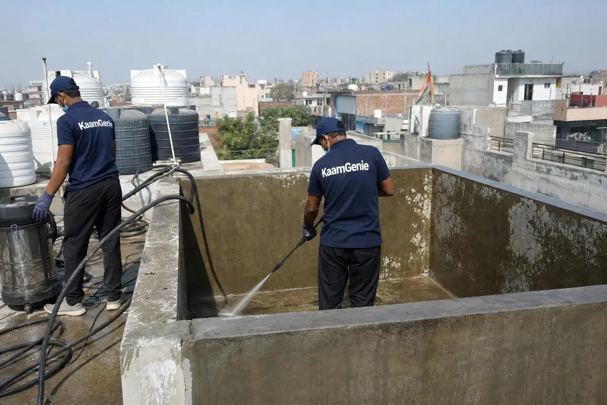 KaamGenie crew cleaning a overhead (rooftop) tank in Najafgarh, Delhi
