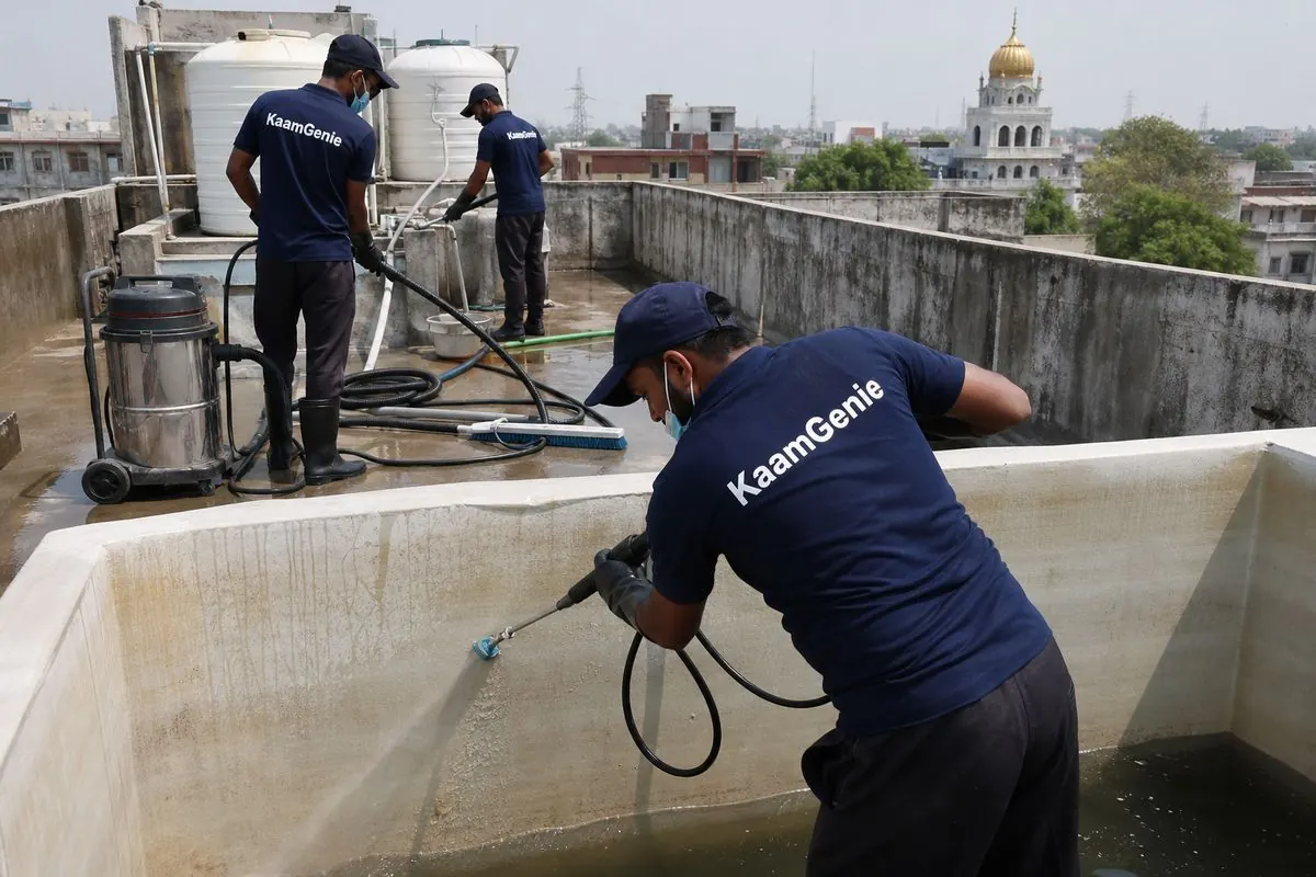 KaamGenie crew cleaning a overhead (rooftop) tank in Nanakpura, Delhi