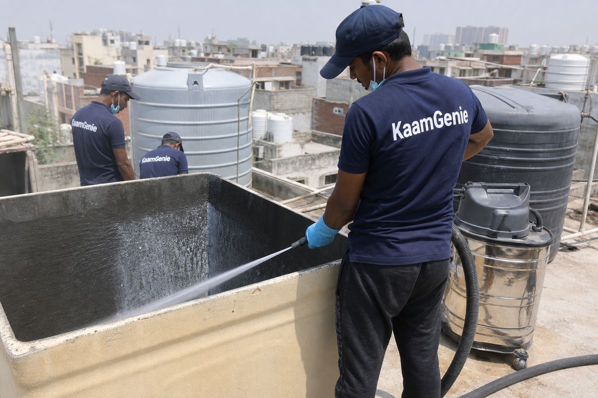 KaamGenie crew cleaning a overhead (rooftop) tank in Nand Nagri (C Block), Delhi
