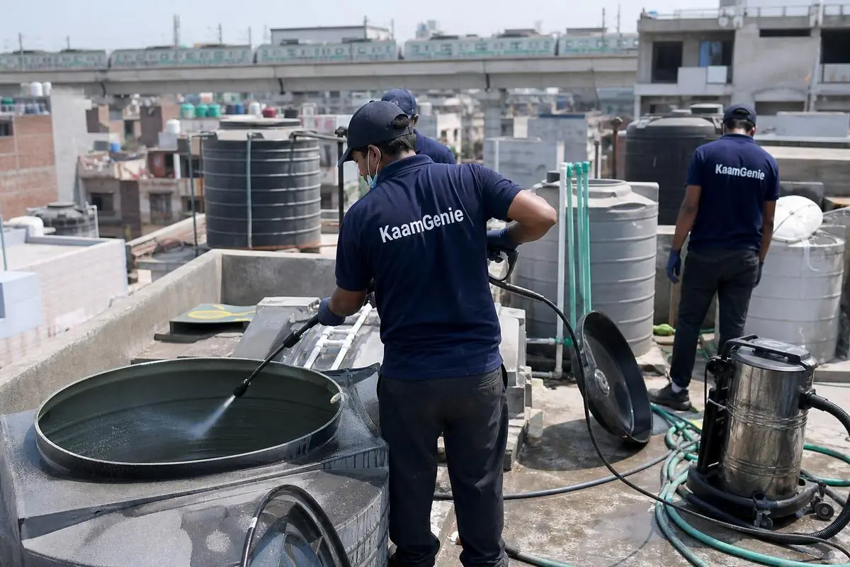 KaamGenie crew cleaning a overhead (rooftop) tank in Nangloi, Delhi