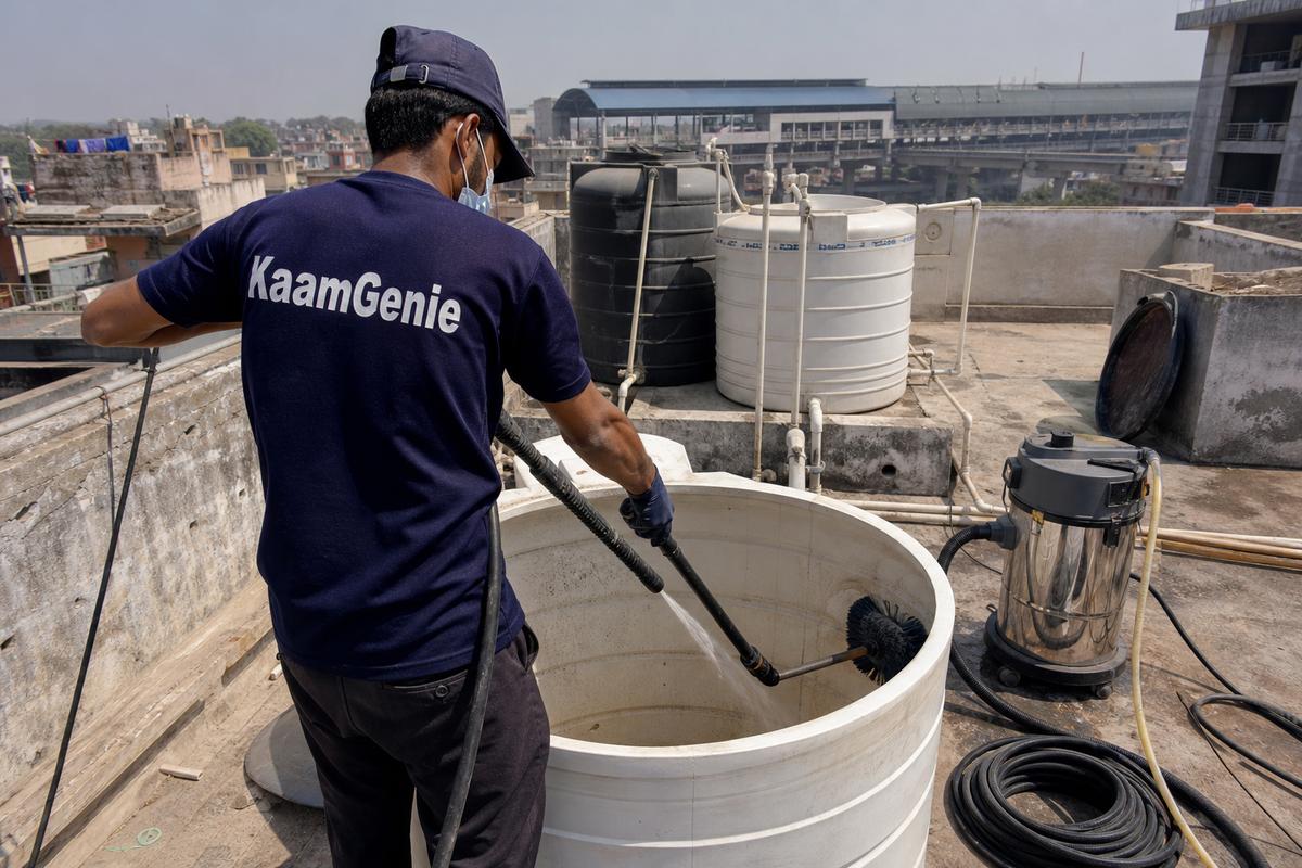 KaamGenie crew cleaning a overhead (rooftop) tank in Nawada, Delhi