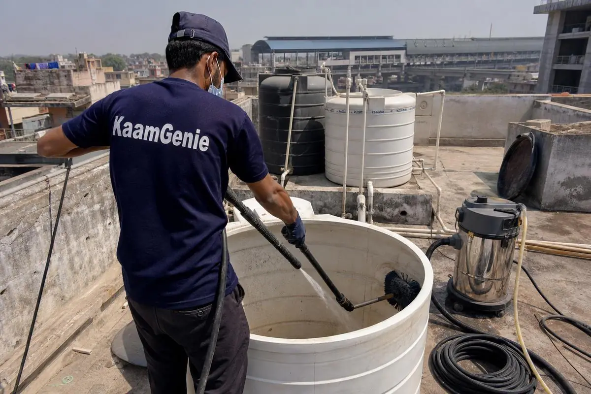 KaamGenie crew cleaning a overhead (rooftop) tank in Nawada, Delhi
