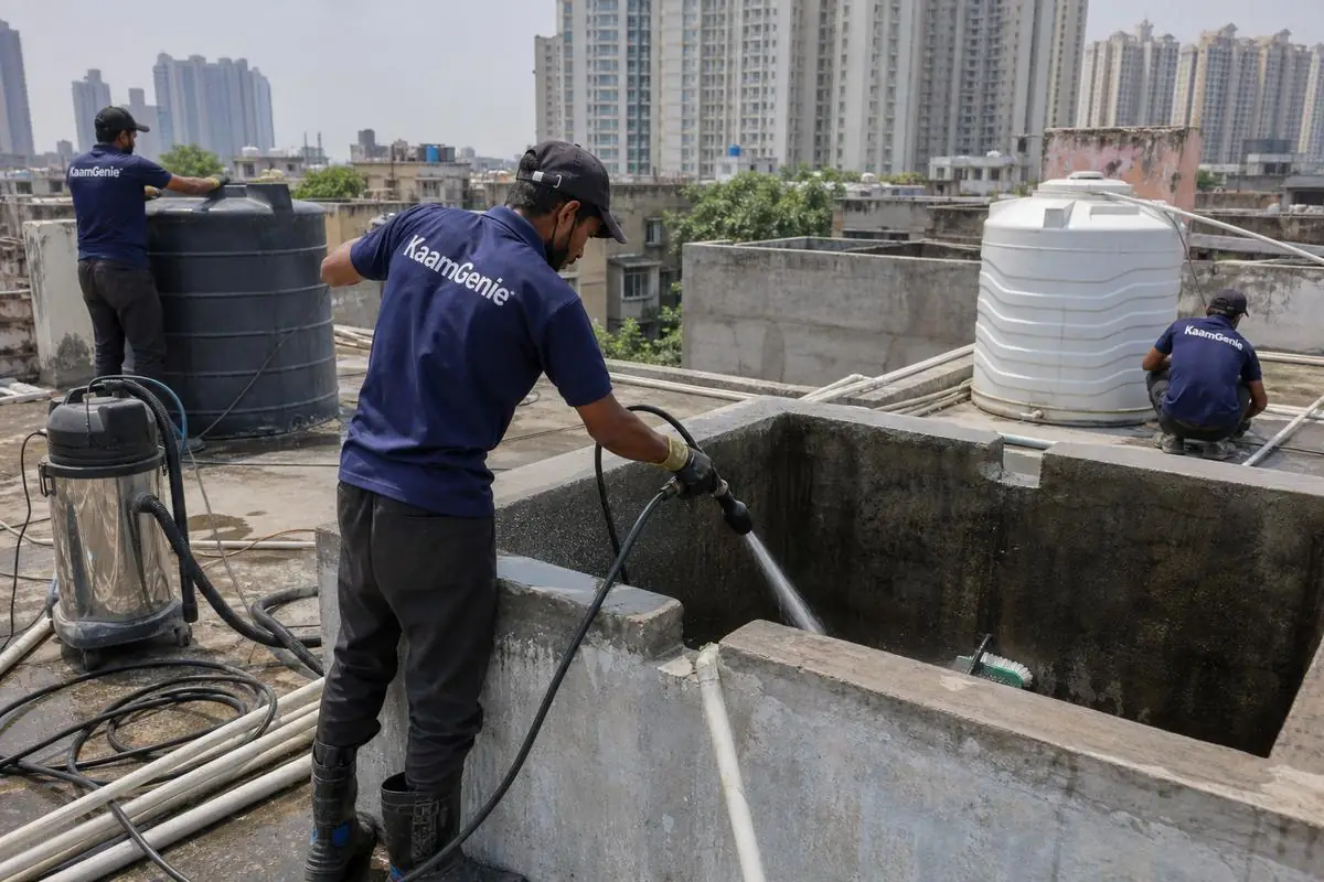 KaamGenie crew cleaning a overhead (rooftop) tank in Netaji Nagar, Delhi