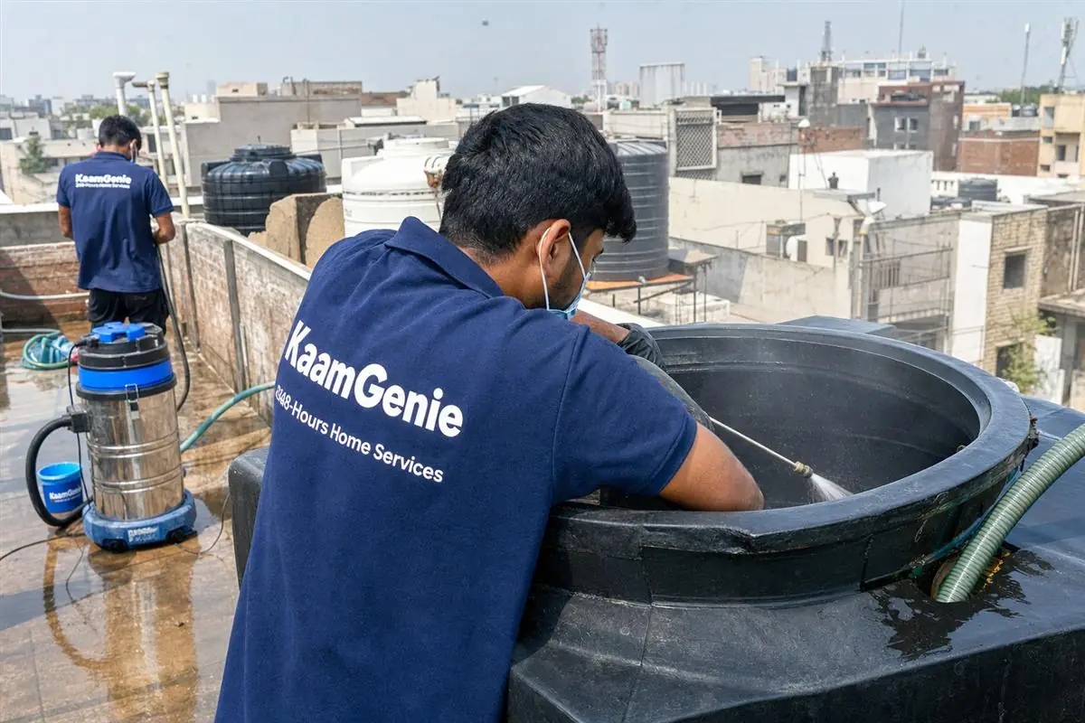 KaamGenie crew cleaning a overhead (rooftop) tank in Okhla Phase 2, Delhi