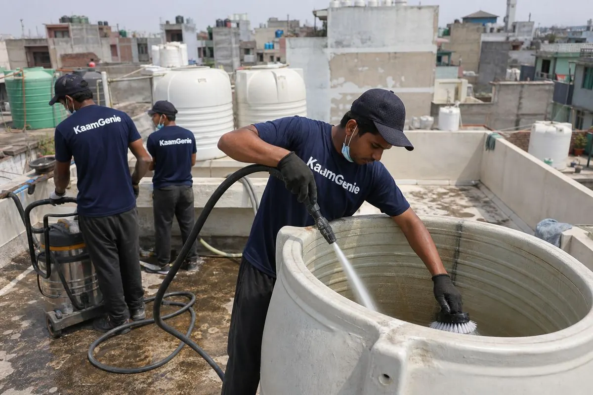 KaamGenie crew cleaning a overhead (rooftop) tank in Padam Nagar (Kishan Ganj), Delhi